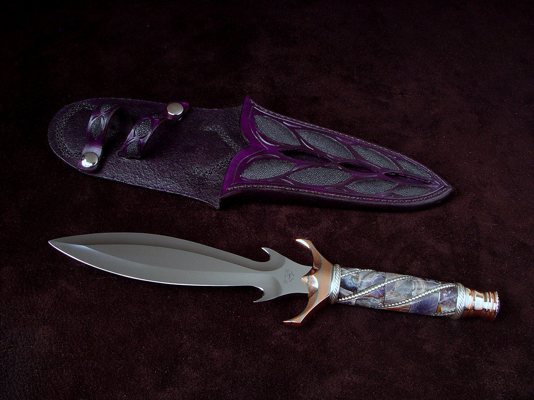 "Amethistine" dagger, obverse side view in 440C high chromium stainless steel blade, diffusion welded copper, nickel silver fittings, sterling silver gallery wire wrap and accents, Amethyst crystal gemstone pommel, hand-carved leather sheath inlaid with black rayskin "Amethistine" dagger, obverse side view in 440C high chromium stainless steel blade, diffusion welded copper, nickel silver fittings, sterling silver gallery wire wrap and accents, Amethyst crystal gemstone pommel, hand-carved leather sheath inlaid with black rayskin