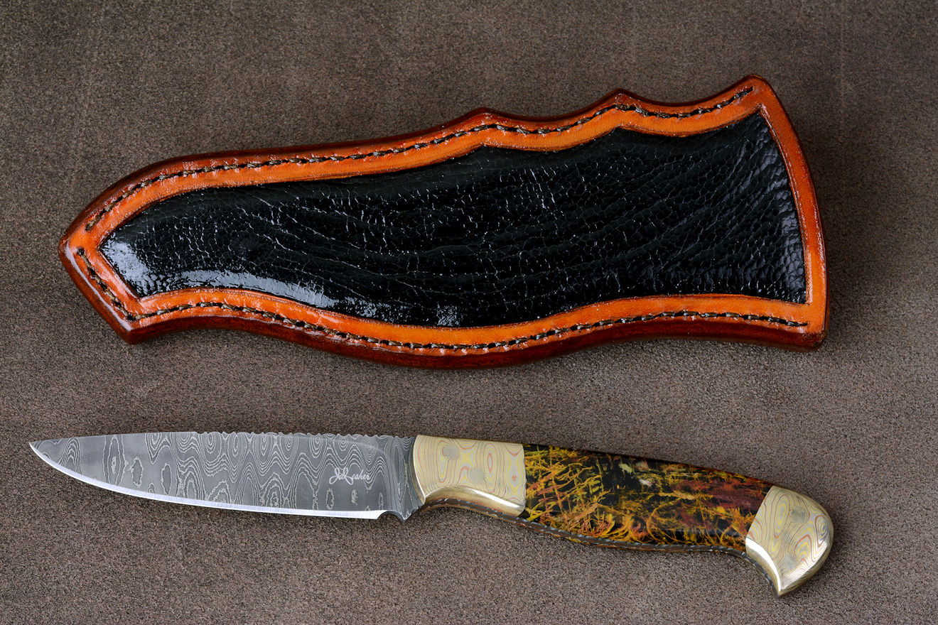 "Tarazed" in stainless steel pattern welded damascus blade, mokume gane diffusion welded and forged bolsters, Pilbara Picasso Jasper gemstone handle, hand-carved leather sheath inlaid with ostrich leg skin "Tarazed" in stainless steel pattern welded damascus blade, mokume gane diffusion welded and forged bolsters, Pilbara Picasso Jasper gemstone handle, hand-carved leather sheath inlaid with ostrich leg skin