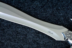 "Achelous" blade detail. Blade is ground by hand with a three inch contact wheel, for radical and difficult to produce geometry that preserves a thick center spine. "Achelous" blade detail. Blade is ground by hand with a three inch contact wheel, for radical and difficult to produce geometry that preserves a thick center spine.