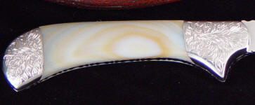White geodic agate with hand-engraved stainless steel bolsters White geodic agate with hand-engraved stainless steel bolsters