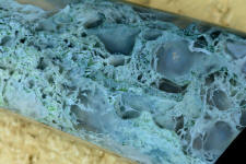 10 power magnification of Horse Canyon Plume Agate shows intense mossy forms and crystal pockets 10 power magnification of Horse Canyon Plume Agate shows intense mossy forms and crystal pockets