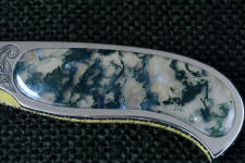 Translucent to transparent, Indian Green Moss Agate gemstone is inlaid in this stainless steel folding knife frame/liner Translucent to transparent, Indian Green Moss Agate gemstone is inlaid in this stainless steel folding knife frame/liner
