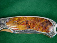 Pietersite Agate inlaid in interframe folding knife with stainless steel hand-engraved liners Pietersite Agate inlaid in interframe folding knife with stainless steel hand-engraved liners